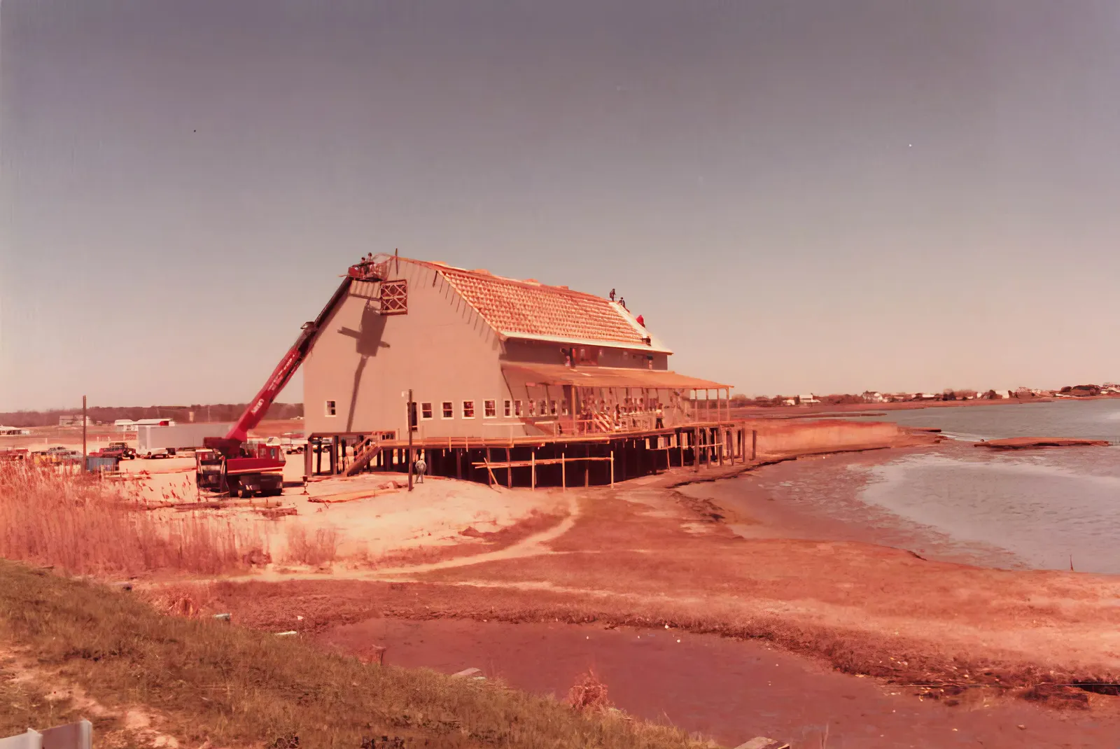 The original Hooper's Crab House under construction on the West Ocean City waterfront in 1981, with a crane raising the roof