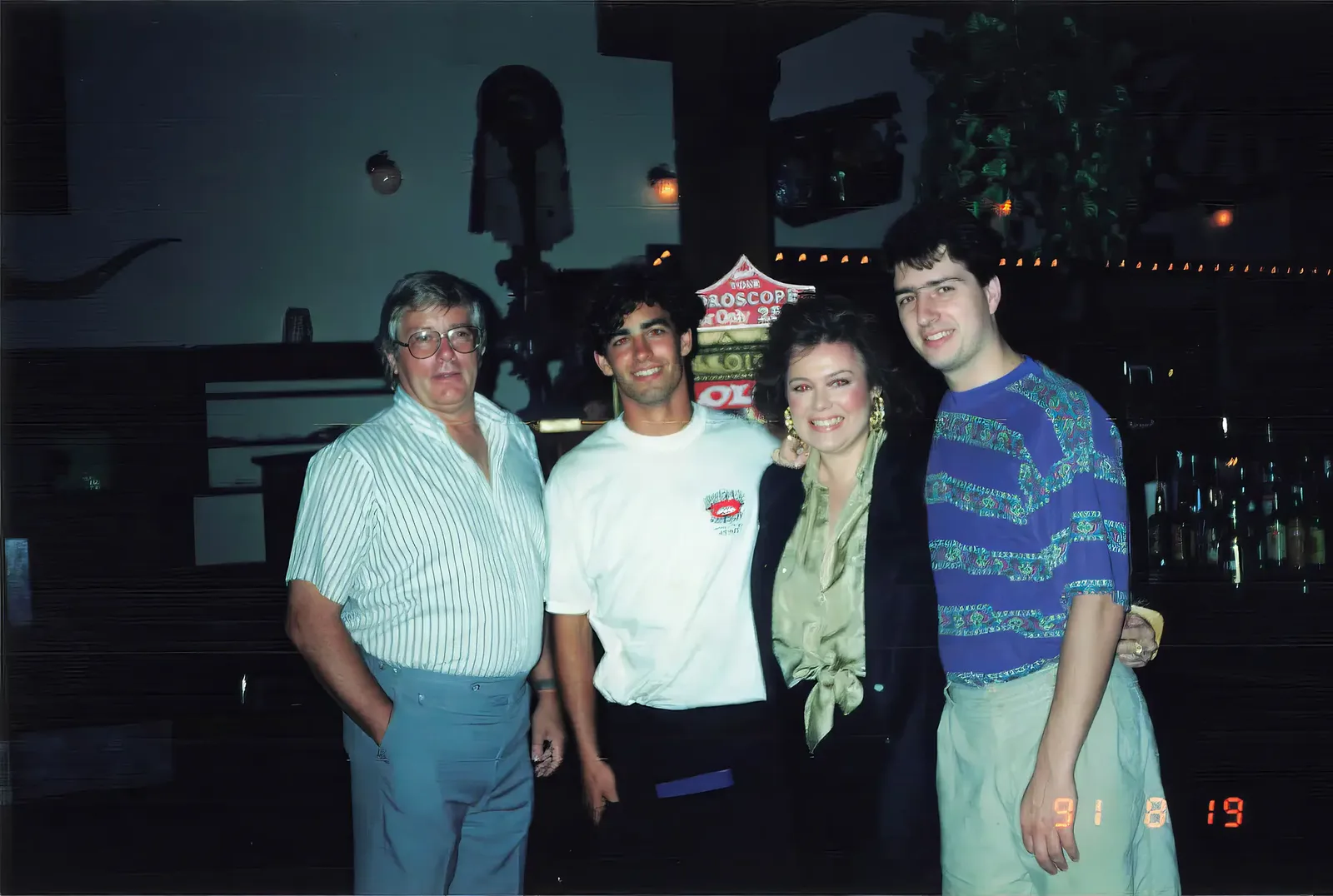 Pete and Royette Shepherd with family inside Hooper's Crab House in 1991, standing together by the bar