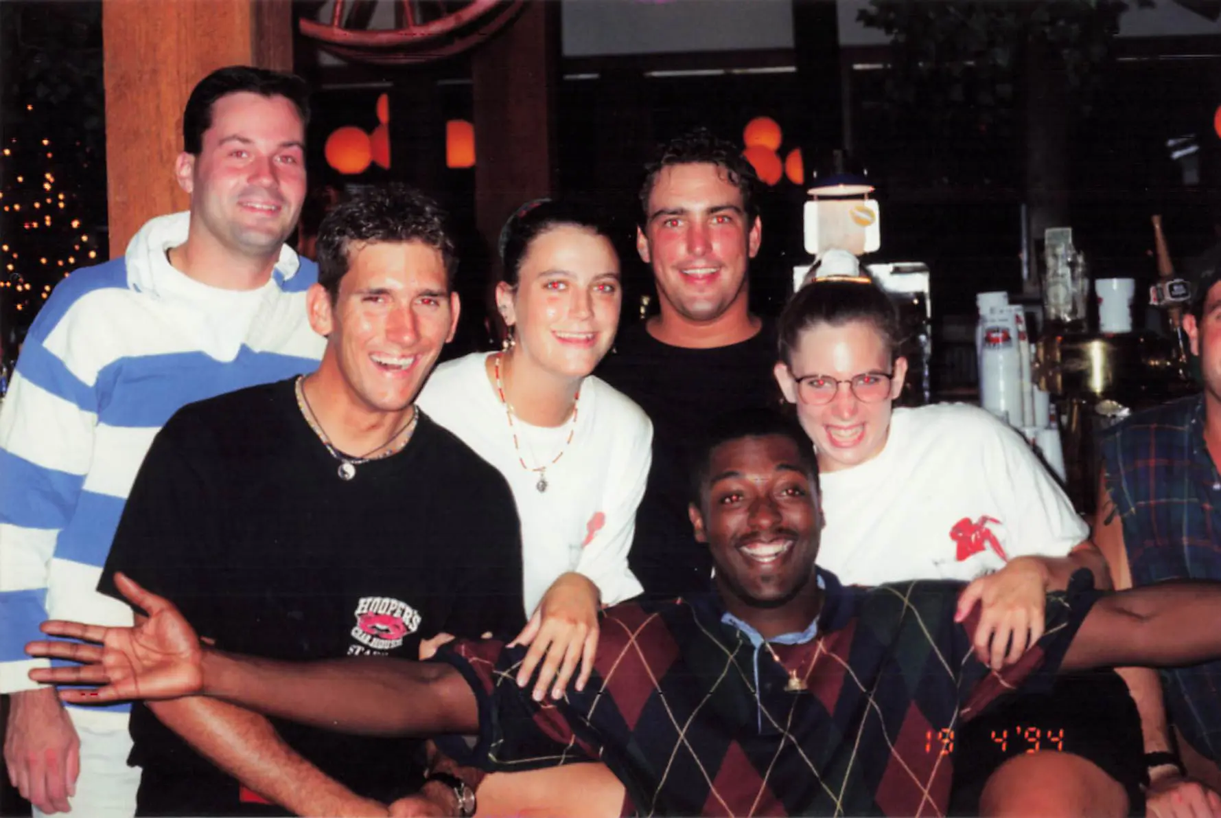 Six Hooper's Crab House staff members posing together and laughing inside the restaurant in 1994