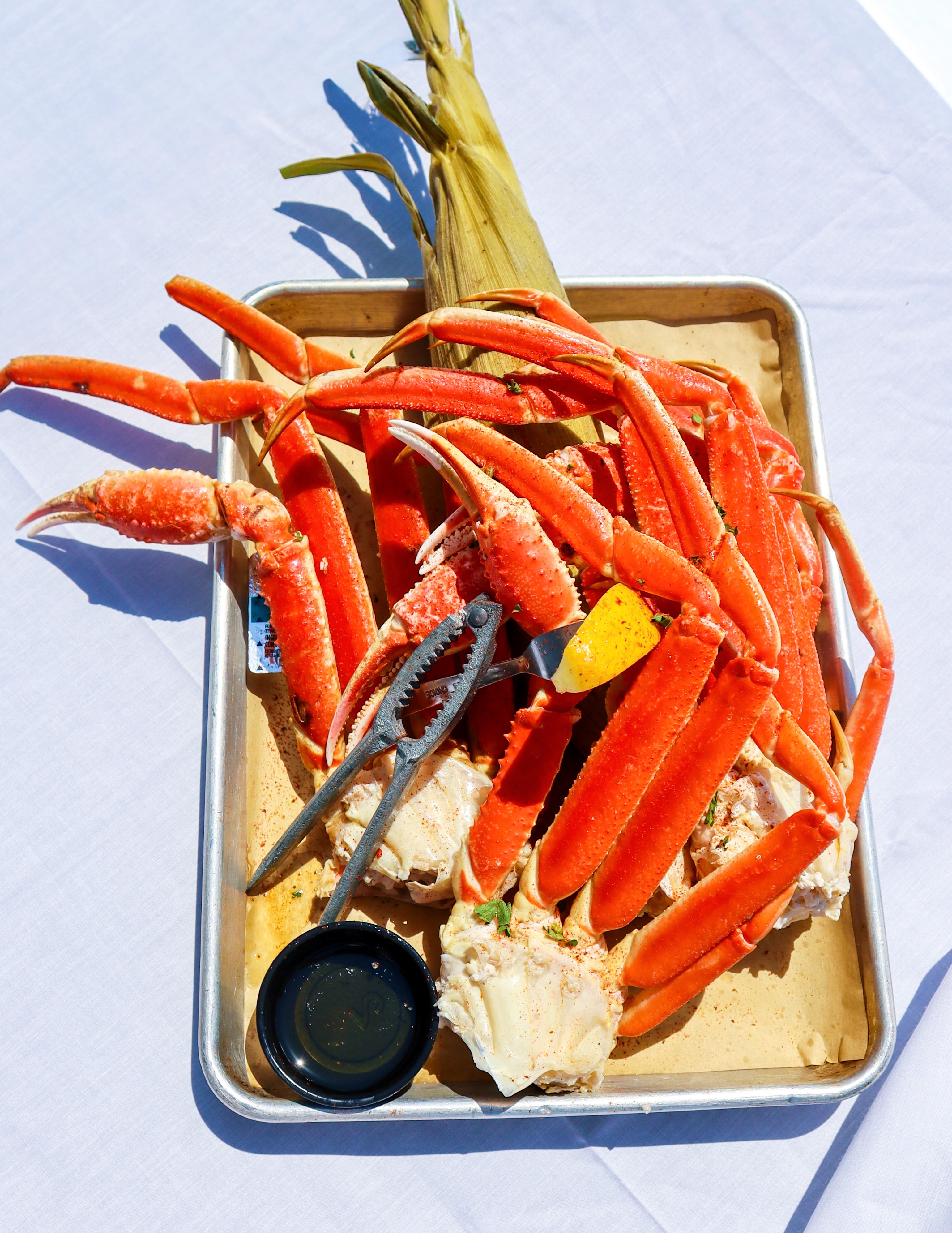 Fresh crab legs served on a tray at Sneaky Pete's